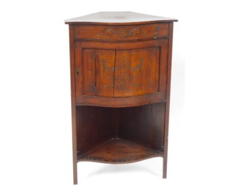 An Edwardian walnut corner cabinet, with a bow front, with carved panel door and single shelf base, 99cm high, 60cm wide, 42c