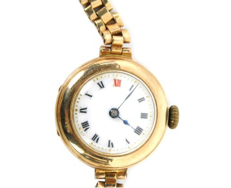 A late 20thC 9ct gold wristwatch, the circular watch head with white enamel Roman numeric dial, on a three bar bracelet, stam