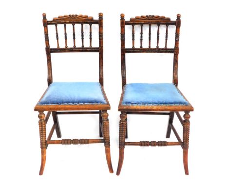 A pair of William IV beech dining chairs, painted to simulate rosewood, each with reeded fan carving and blue velvet button l