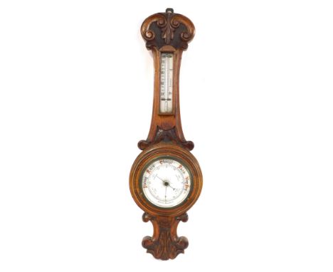 A late 20thC oak aneroid barometer, with white ceramic dial, 66cm high. 