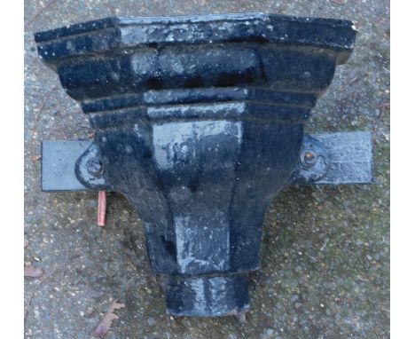 A black painted metal drain hopper.