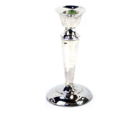 A George V silver taper candlestick, on a reeded column with weighted base, Birmingham, hallmarks rubbed, 5.68oz gross. 
