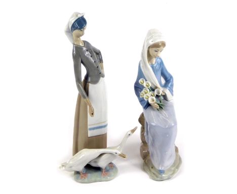 A Lladro porcelain figure of a lady seated holding a clutch of Calla lilies, together with a Lladro porcelain figure of a lad