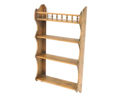 A Victorian pine hanging wall shelf, with a galleried upper shelf above three further shelves, within shaped ends, 54cm high,