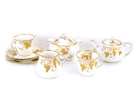 A Hammersley china two piece tea service, on a white ground with gilt grape vine decoration, comprising milk jug, cake plate,