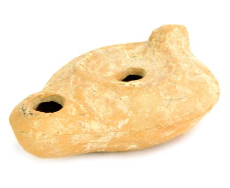 A Roman pottery oil lamp, 9cm diameter.