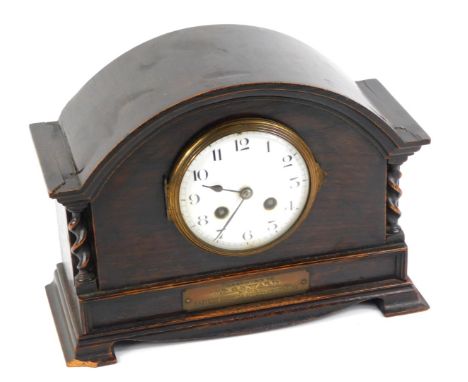 An early 20thC oak cased mantel clock, the circular enamel dial bearing Arabic numerals, French eight day movement with bell 