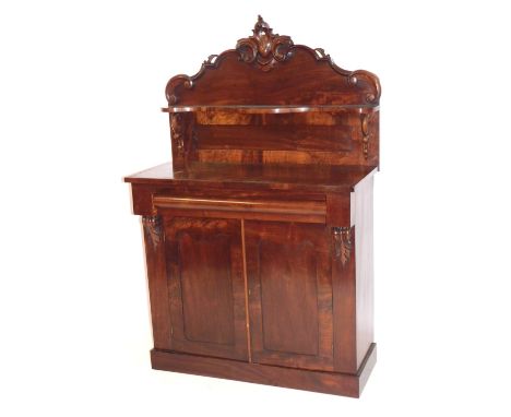 A Victorian mahogany chiffonier, carved shaped back with a single serpentine shelf raised on scroll supports, above one long 