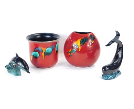 Four items of Poole pottery, comprising a red Delphis planter, 15cm high, red Delphis vase, 20cm high, and two Poole pottery 