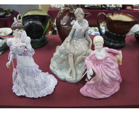 Coalport Figurines 'Eugenie' and another of a Lady dressed in pink and holding a fan, Nao figurine (chipped finger). (3)