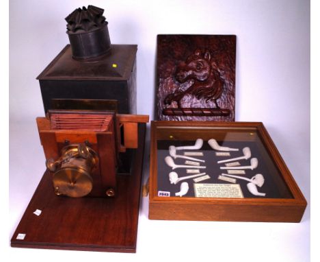 A CASED SET OF CLAY PIPE DESIGNS (3)Together with a magic lantern and carved wooden armorial plaque
