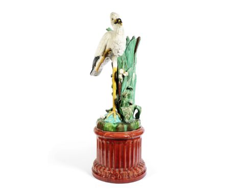 A late 19th century Majolica glazed earthenware stork stick stand and pedestalin the Minton stylethe stork modelled with a wa