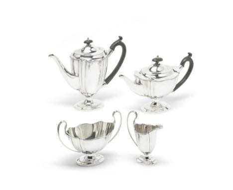 A four-piece silver tea and coffee serviceWilliam Hutton &amp; Sons, London 1910 Fluted oval form, the pots with wood handles