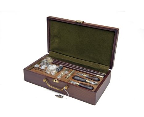 A NEW AND UNUSED PRESENTATION DELUXE 12-BORE GUN CLEANING KIT, fitted partitioned tray with separate compartments containing 