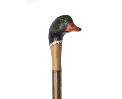 A FINE NEW AND UNUSED CARVED WALKING STAFF, measuring approx. 53in. in length, hard wood shaft, the top carved and painted in