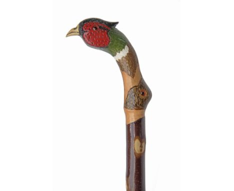 A FINE NEW AND UNUSED CARVED WALKING STAFF, measuring approx. 52in. in length, with hardwood shaft, the top carved and painte