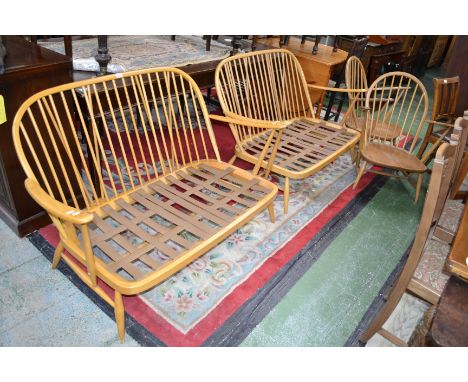 Two light elm Ercol two seat settees; two light elm Ercol armchairs (4)