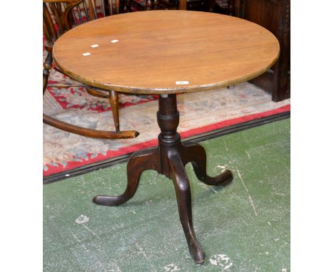 A George III oak tilt top tripod table, circular top, baluster column, cabriole supports, pad feet. 73cm high x 79cm diameter