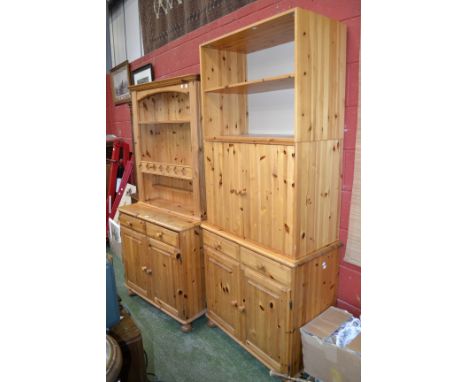 A contemporary pine dresser, stepped cornice, three shelves to top, two short drawers over two fielded panel door cupboard to