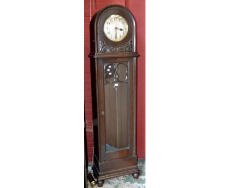 An oak dome topped longcase clock, silvered dial, Arabic numerals, glazed door, turned feet, circa 1920/30