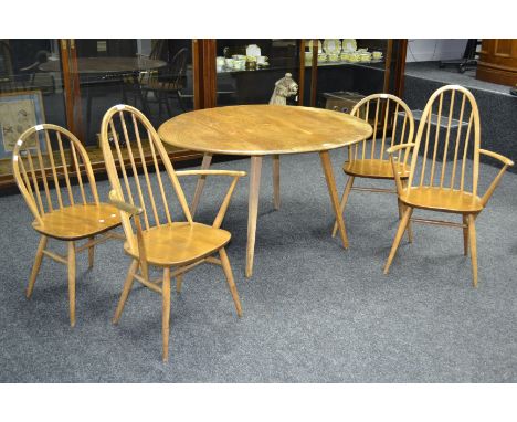 A light elm Ercol dropleaf dining table; two spindle back carvers and two spindle back dining chairs. (5)