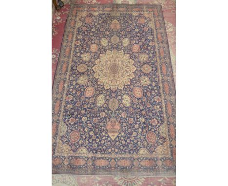 An antique Middle Eastern woollen carpet. 233cm x 137cm approximately.