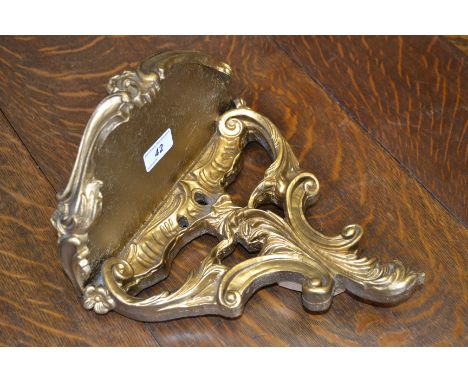 A giltwood wall bracket, made by Atsonea, pierced with leafy scrolls, 28cm high