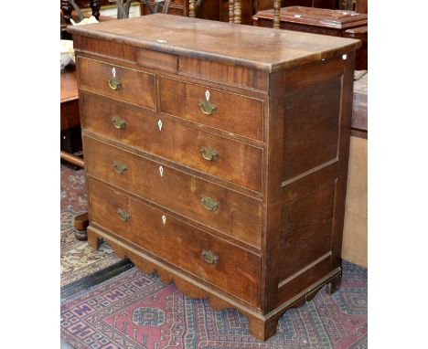 A George III oak chest and mahogany chest of two short and three long graduated cockbeaded drawers, deep frieze centred by a 