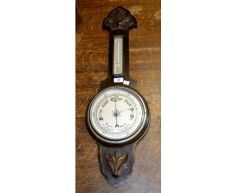 An Edwardian oak cased aneroid barometer and thermometer