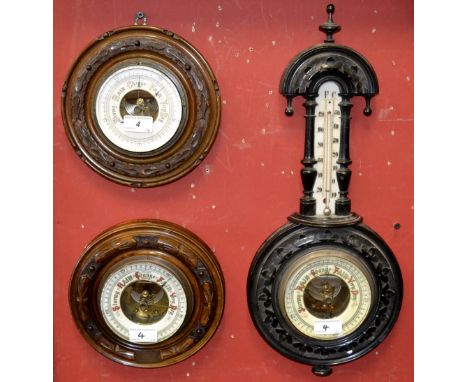 A Victorian ebony aneroid barometer; a Victorian circular barometer; another (3)