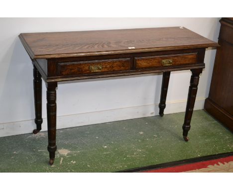 An early 20th century oak hall table, having a pair of drawers to frieze, turned legs, ceramic casters, 119cm wide x 45cm dep