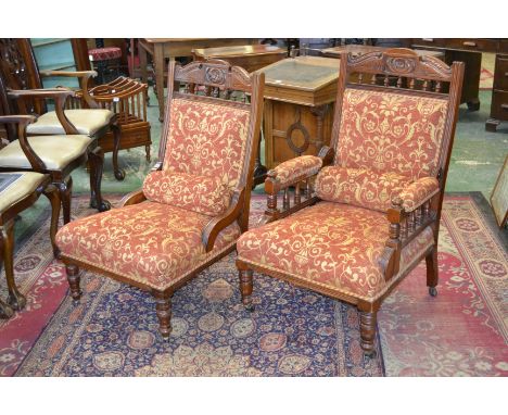 A pair of Edwardian salon chairs, shaped and carved top rail, padded back and seat, turned forelegs, ceramic casters, c.1910 