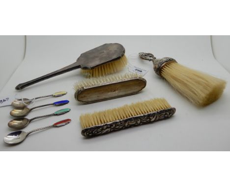 A lot comprising a silver handled crumb brush, Chester 1897, four silver and enamel coffee spoons, Birmingham 1936 and a thre