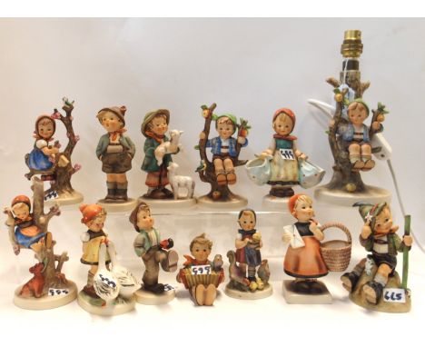 A Hummel apple tree boy table lamp and twelve Hummel figures of medium size Condition Report: All in good condition. Table la