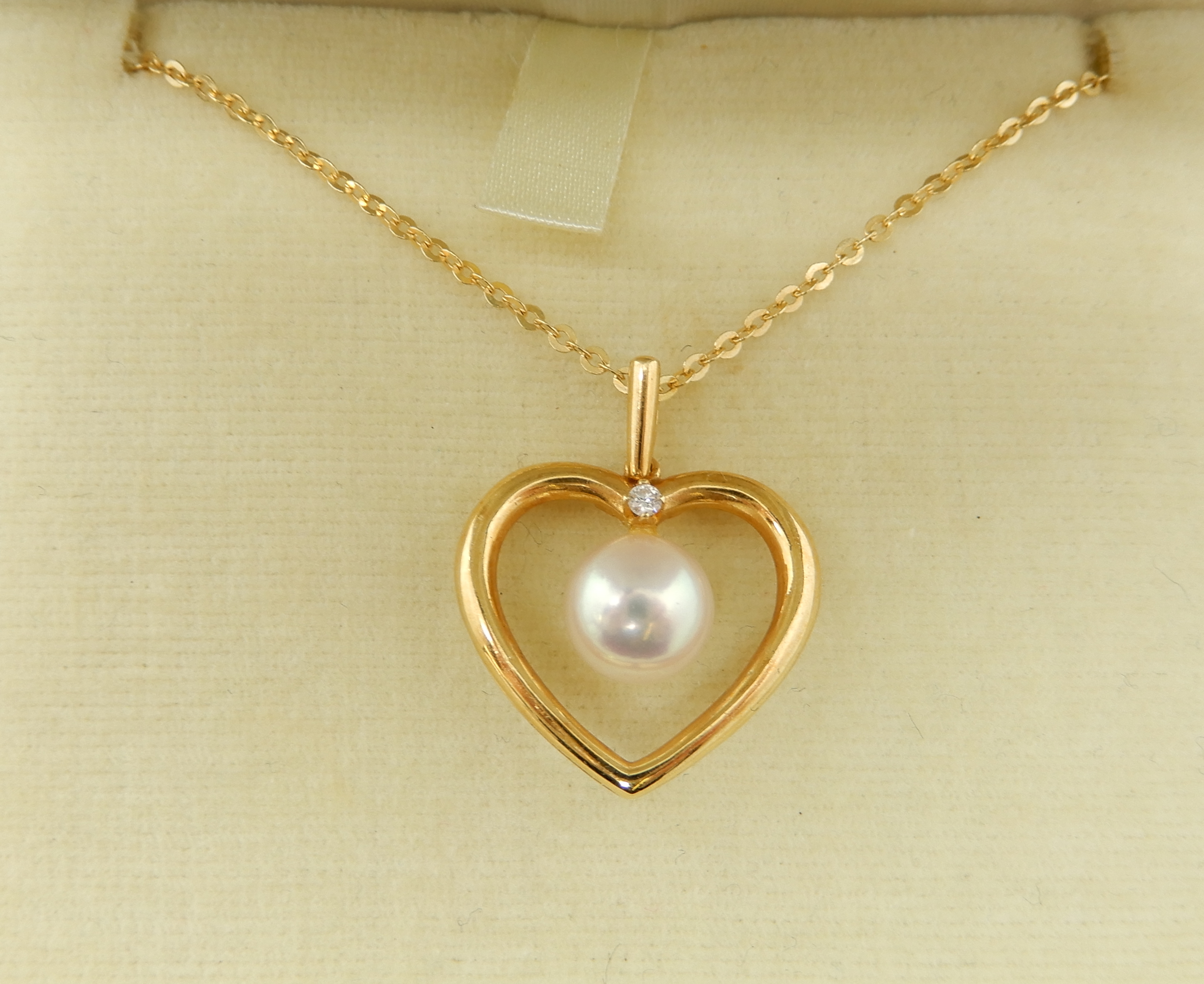 An 18ct gold Mikimoto, diamond and pearl heart shaped pendant, 2.2cm