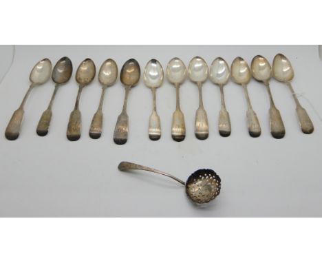 A set of twelve silver teaspoons, Glasgow 1860 and a silver sifter ladle Birmingham 1911, 255gms (13) Condition Report: Avail