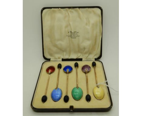 A cased set of six silver gilt and enamel coffee spoons, Birmingham 1933 Condition Report: Available upon request
