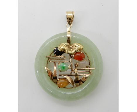 A 14k gold mixed gem set Chinese green hardstone rondel pendant, approx diameter 3.3cm, weight 11.4gms Condition Report: Ligh