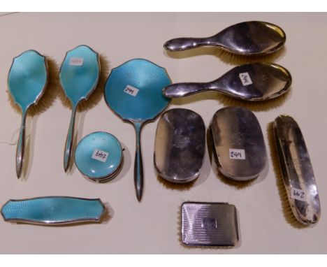 A lot comprising a four piece silver and enamel dressing table set, Birmingham 1942 and seven assorted silver mounted brushes