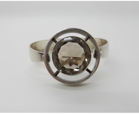 A silver and smoky quartz retro bangle by NE From of Denmark Condition Report: A few tiny flea bite chips to the extremities 