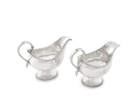 A pair of George III silver sauceboatsJohn Carter, London 1772 Each oval bellied form on spreading oval bases with bead rims,