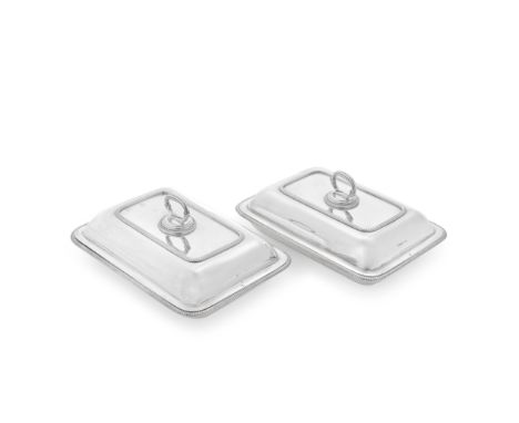 A pair of George III silver entrée dishes and coversThomas Robins, London 1806 and 1807 Rectangular form with gadroon rims, t