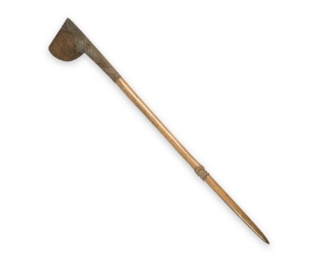 A New Zealand Maori carved wood long club (Tewhatewha)possibly late 19th/early 20th century, the expanded axe-like blade with