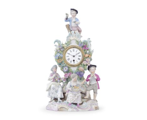 A late 19th century Continental porcelain figural mantel timepiecein the Meissen stylethe floral encrusted waisted scrolling 