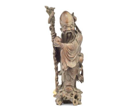 A large Chinese carved hardwood figure of Shoulaoprobably 19th century, the elderly god clad in a draped robe, holding a peac