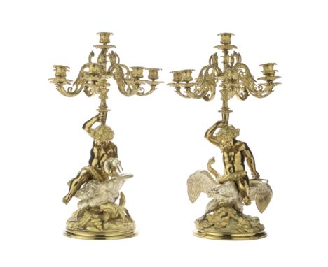 A pair of late 19th century French gilt and silvered bronze eight-light figural candelabrathe figures in the manner of Claude