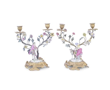 A pair of late 19th/early 20th century Continental gilt bronze and brass mounted porcelain figural twin-light candelabrain th