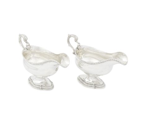 A pair of George III silver sauceboatsWilliam Sumner, London 1766 Each oval bellied form with gadroon rim, leaf-capped scroll