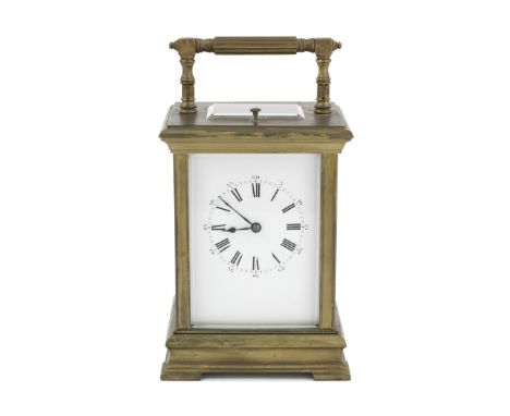 An early 20th century brass carriage clock with repeatthe Anglais case with angular reeded bar swing handle, the rectangular 