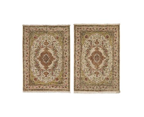 A pair of part silk Tabriz carpetsc.1970, signed Majid Jami, North West Persia,on oatmeal ground, the tan medallion with ligh